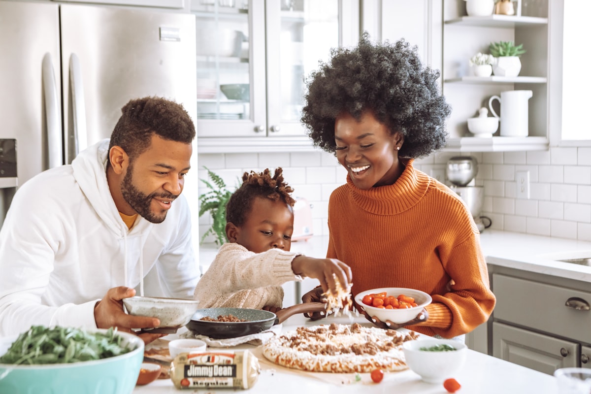 Family cooking together in a bright kitchen